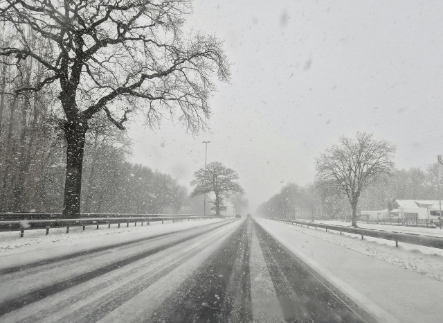 A road covered by snow during a winter storm
